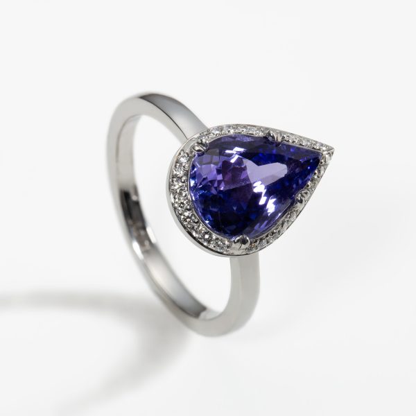 18ct white gold halo engagement ring with pear cut 2.5ct tanzanite in a four claw setting with 26 x 1mm pave set diamonds