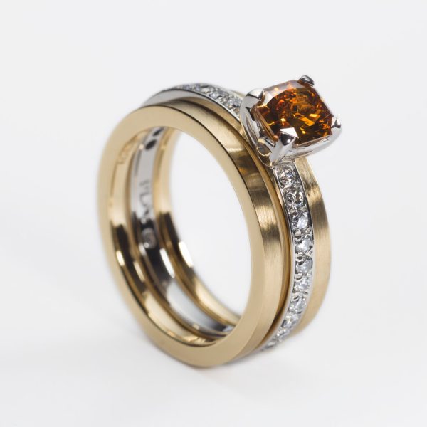 Platinum engagement ring with 0.78ct fancy cognac diamond and pave diamond set shoulders,