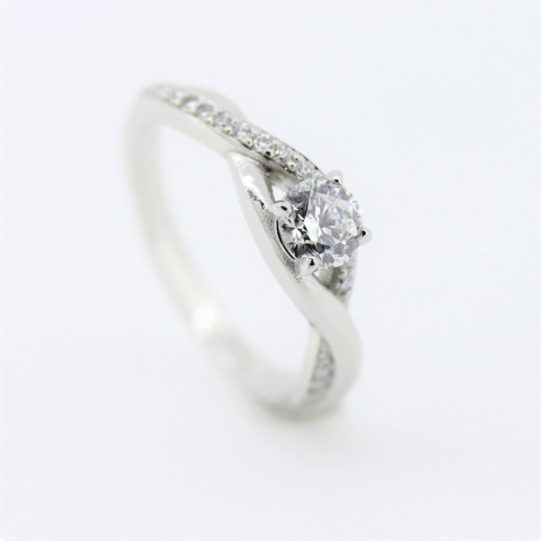Achill platinum engagement ring with 0.50ct, E, SI1, in claw setting. Diamonds pave set into braids