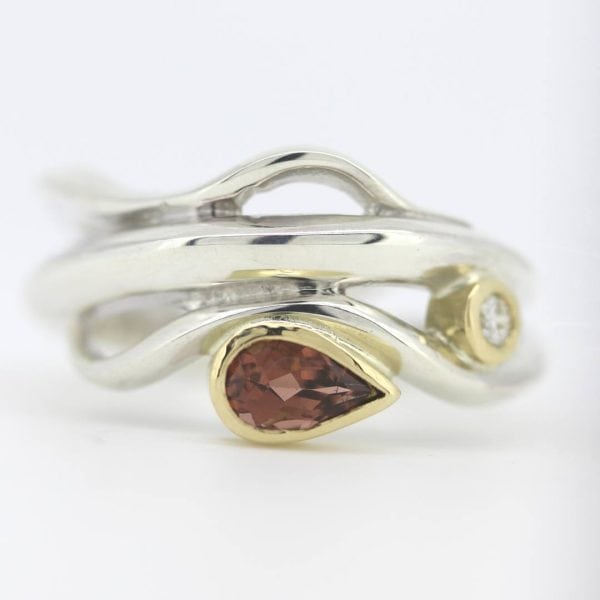 Silver Wave ring set with a deep peach coloured, pear cut tourmaline and 2.5mm diamond in 18ct yellow gold settings.