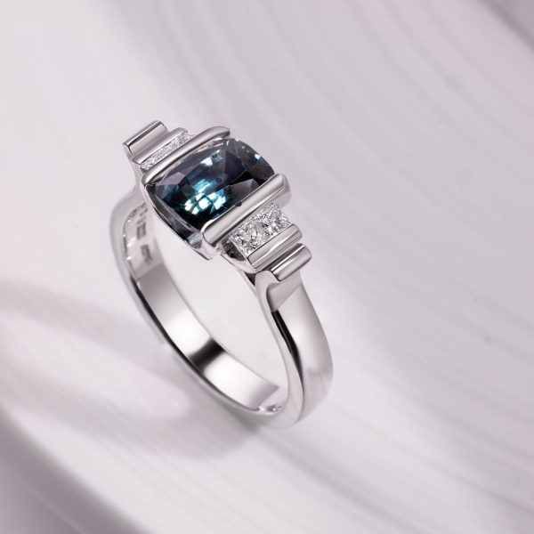 Platinum Art Deco ring set with a 2.03ct BlueGreen Cushion cut Sapphire and 4 x 2.1mm princess cut diamonds, €5,100