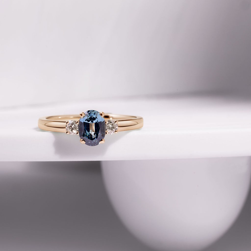 18ct yellow gold three stone claw set ring with 1.09ct oval, blue Gombe Sapphire and 2 x 2.8mm round brilliant cut diamonds, €3,900