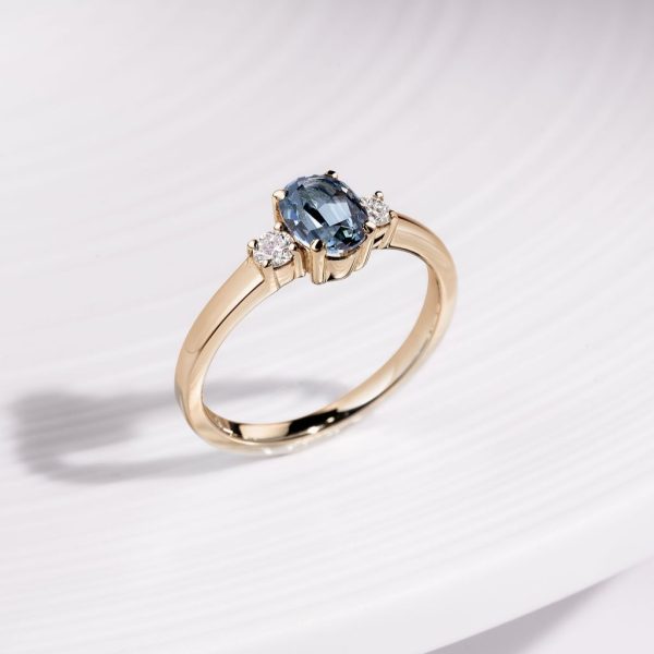 18ct yellow gold three stone claw set ring with 1.09ct oval, blue Gombe Sapphire and 2 x 2.8mm round brilliant cut diamonds, €3,900