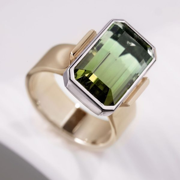 7mm 18ct yellow gold band 9.10ct emerald cut Bi-Colour green tourmaline in platinum setting with 11 x 1mm diamonds pave set, €10,500