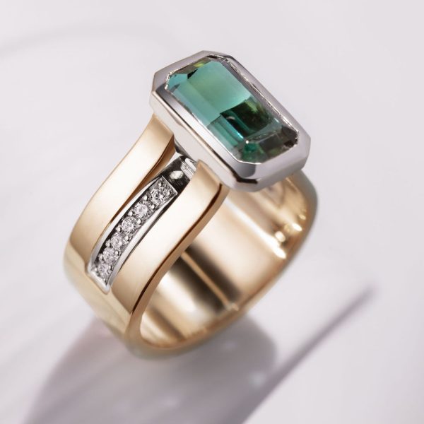 9mm 18ct yellow gold band w platinum inlay and setting 4ct octagonal indigolite and pave diamonds under setting in shoulders €12,850